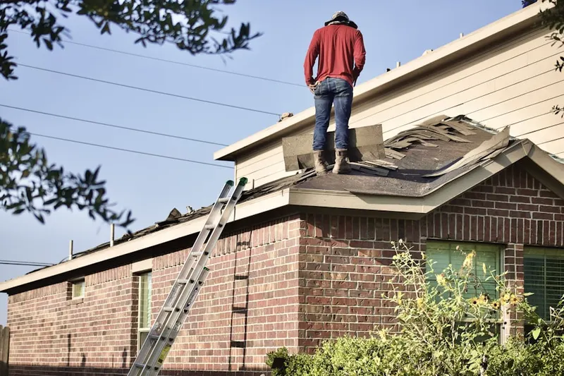 Professional roofer working on a residential roof in Dorset Village